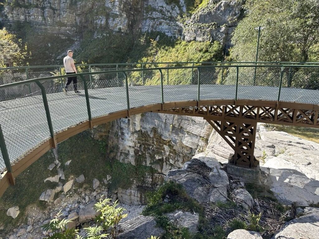 Bridge over the canyon at the Kinchkha waterfall